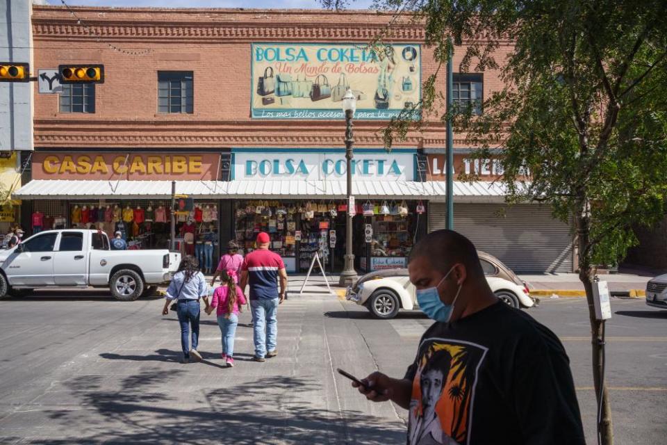 People wearing masks amid the Covid-19 pandemic are pictured on October 24, 2020 in downtown El Paso, Texas.