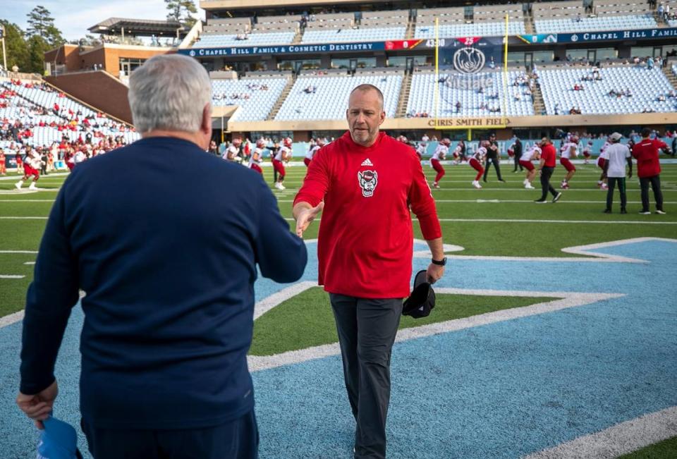 N.C. State coach Dave Doeren greets North Carolina coach Mack Brown prior to their game on Friday, November 25, 2022 at Kenan Stadium in Chapel Hill, N.C.