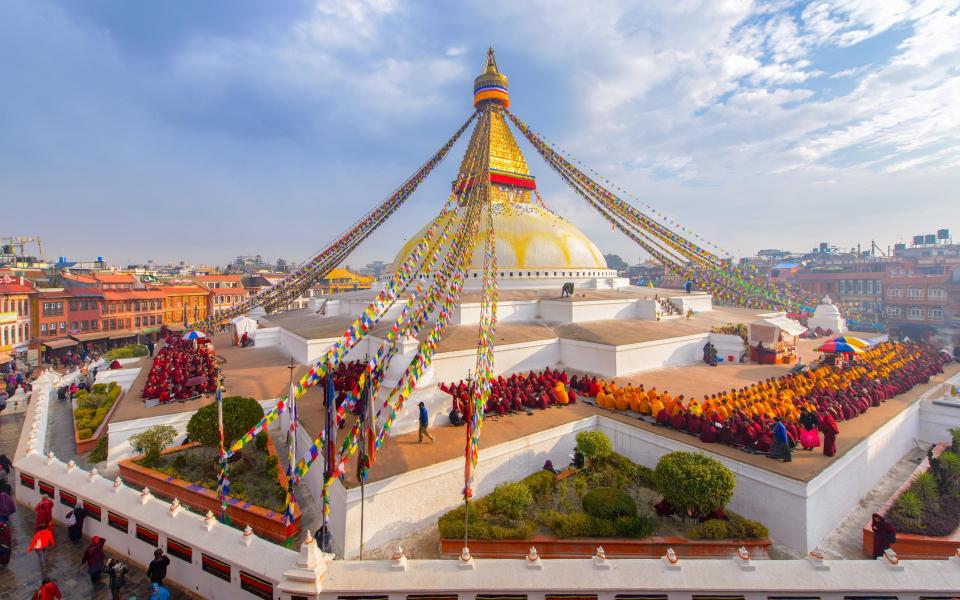 Prayer flags on a Buddhist stupa in Boudhanath, Kathmandu - Getty