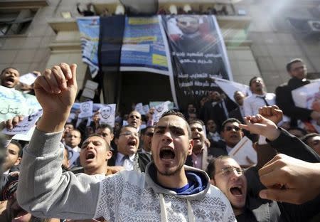 Lawyers shout slogans against the Interior Ministry during a protest in front of the Lawyers Syndicate headquarters in Cairo, March 1, 2015, after the death of lawyer Karim Hamdy in the Police Department last week. REUTERS/Mohamed Abd El Ghany