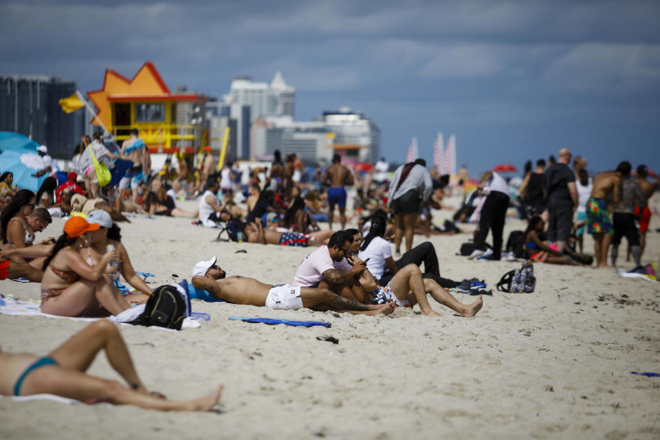 People gather on a beach in Miami, Florida, on Saturday, March 5, 2021. Even with some colleges canceling their mid-semester breaks, students from more than 200 schools are expected to visit Miami Beach during spring break, which runs from late February to mid-April.  / Credit: Eva Marie Uzcategui/Bloomberg via Getty Images