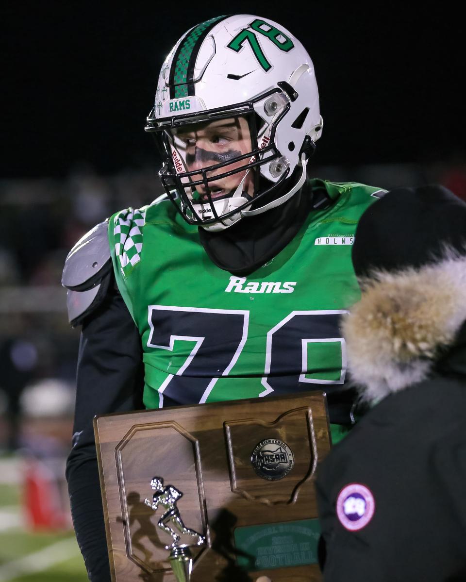 Rams captain Ian Bickert (78) accepts the OHSAA regional runner-up trophy on behalf of his teammates at Trotwood Madison High School on Nov. 18, 2022. The top-ranked Rams fell to Tippecanoe 20-17 on a late field goal.