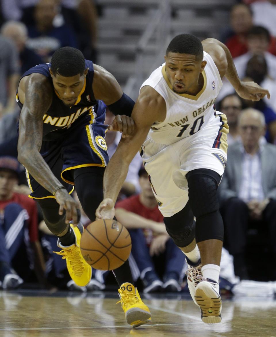 New Orleans Pelicans guard Eric Gordon (10) races for a loose ball with Indiana Pacers forward Paul George during the second half of an NBA basketball game in New Orleans, Wednesday, Oct. 30, 2013. The Pacers won 95-90. (AP Photo/Gerald Herbert)