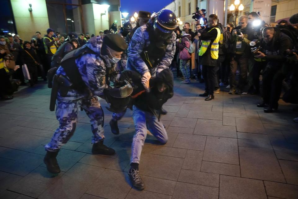 FILE - Riot police detain a young man at a demonstration in Moscow, Russia, Wednesday, Sept. 21, 2022. When protests over the imprisonment of opposition leader Alexei Navalny broke out in 2021, surveillance cameras were used to track down and detain those attending the rallies, sometimes weeks later. (AP Photo, File)