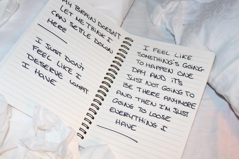 A journal lays open on the bed in the final room of the art installation. Despite the room representing a steady home, the words on the paper express fear and a feeling of being undeserving, a sentiment that Monette said was common amongst participants. 