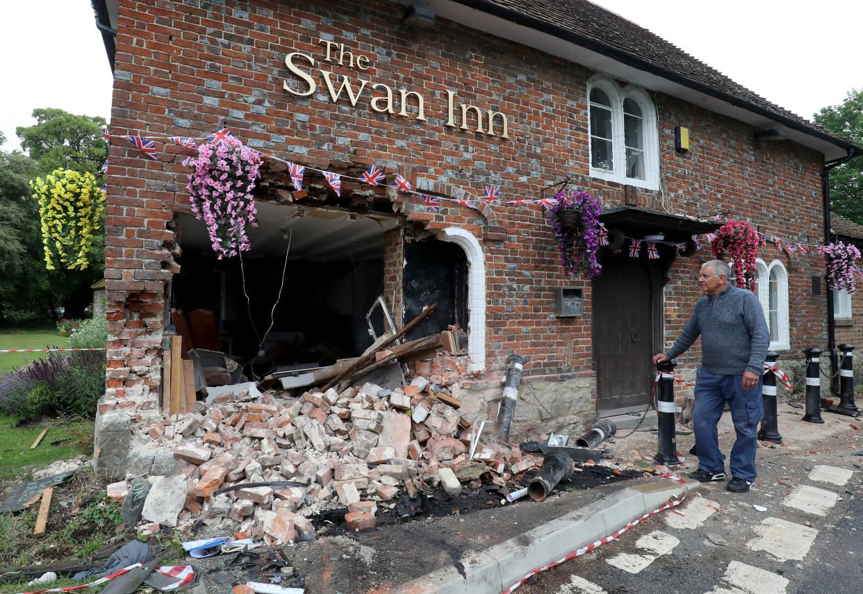 Ray Perkins, Landlord of The Swan Inn in Ashford, Kent, looks at the damage to his pub after a car crashed into the pub during the early hours of this morning wrecking their plans for reopening as coronavirus lockdown restrictions are eased across England.