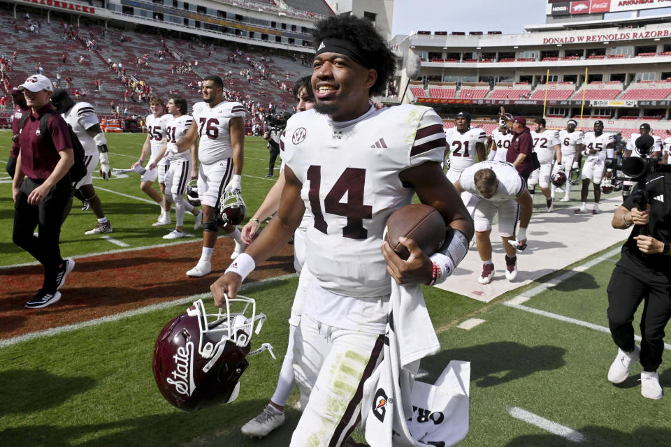 Mississippi State quarterback Mike Wright (14) celebrates on his way off the field after defeating Arkansas in an NCAA college football game Saturday, Oct. 21, 2023, in Fayetteville, Ark. (AP Photo/Michael Woods)