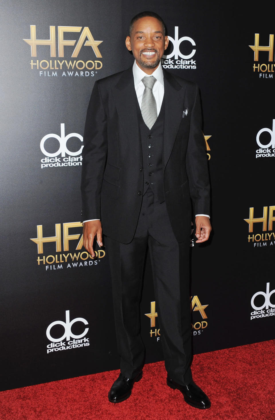 Will Smith in black suit and geometric tie at the 19th Annual Hollywood Film Awards in Beverly Hills, California.