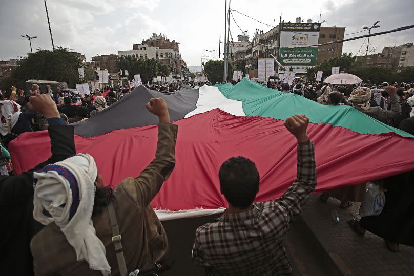 Houthi supporters hold Palestinian flag during a rally in Sana'a, Yemen, 17 May 2021