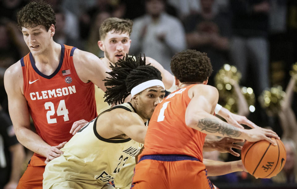 Wake Forest guard Hunter Sallis (23) applies pressure to Clemson guard Chase Hunter (1) during the second half of an NCAA college basketball game, Saturday, March 9, 2024 in Winston-Salem, N.C. (Allison Lee Isley/The Winston-Salem Journal via AP)