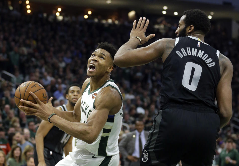 Milwaukee Bucks' Giannis Antetokounmpo drives to the basket against Detroit Pistons' Andre Drummond during the second half of Game 2 of an NBA basketball first-round playoff series Wednesday, April 17, 2019, in Milwaukee. The Bucks won 120-99. (AP Photo/Aaron Gash)