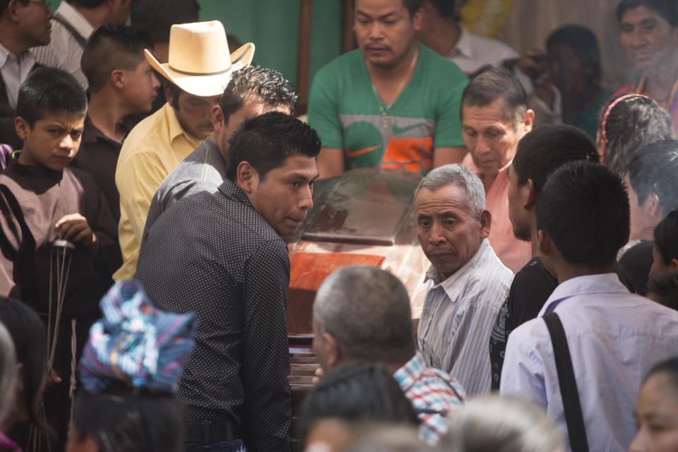 Pall bearers carry the coffin of 10-year-old Carlos Daniel Xiquin, one of two boys who were kidnapped over the weekend and then killed when family could not raise the ransom money, in Ajuix, Guatemala, Tuesday, Feb. 14, 2017. Authorities found the bodies of the two boys on Sunday, stabbed and thrown into sacks in the municipality of San Juan Sacatepéquez, northwest Guatemala. (AP Photo/Moises Castillo)