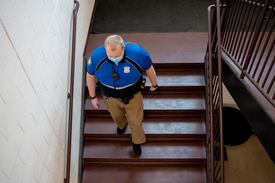 Battle Creek Police Officer Stephen Herbstreith walks to gym class on Thursday, Dec. 9, 2021, at Lakeview High School in Battle Creek, Michigan. Herbstreith, nicknamed "Officer Herbie," is the police liaison for Lakeview schools.