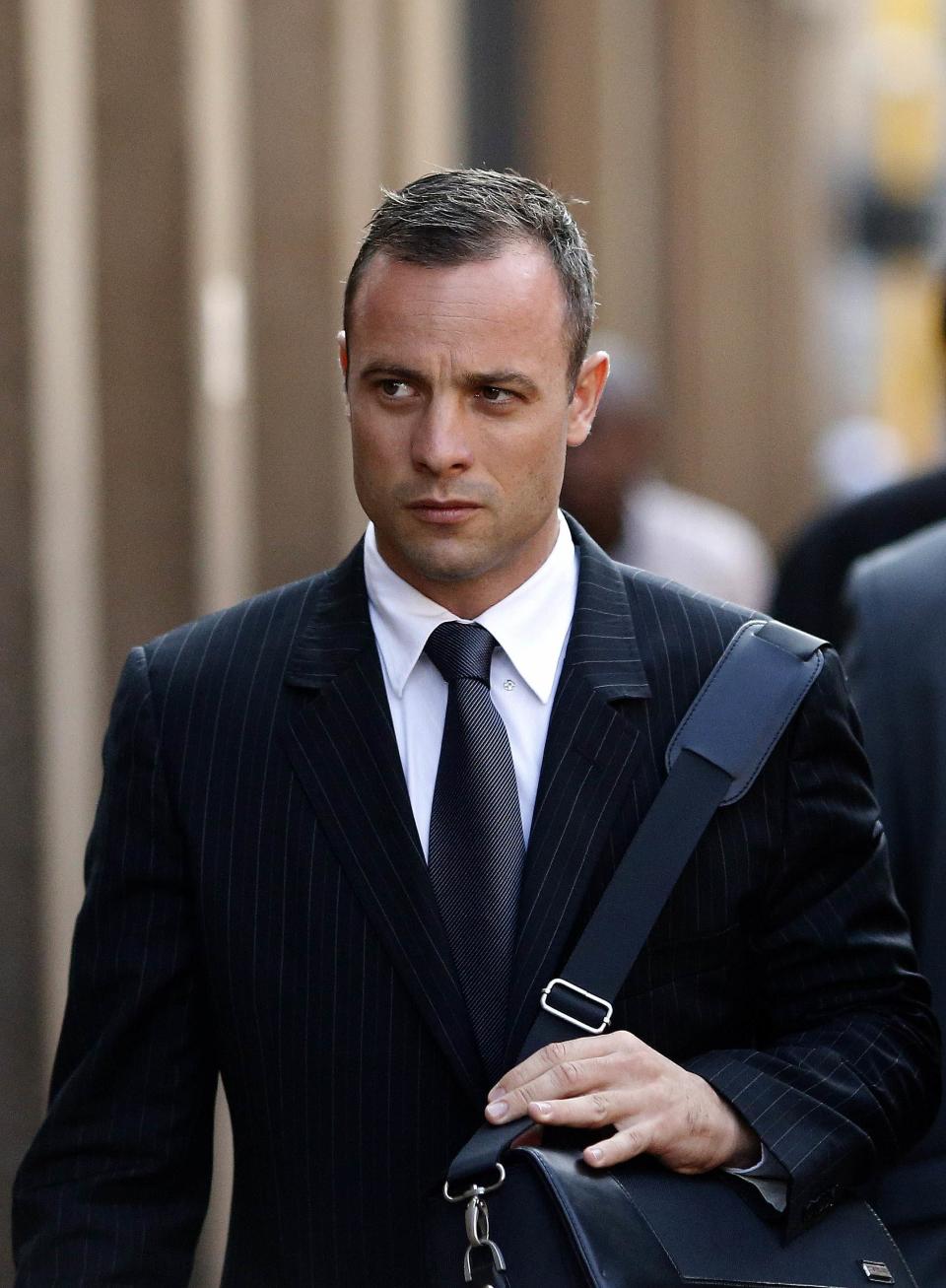 Olympic and Paralympic track star Oscar Pistorius arrives ahead of his trial for the murder of his girlfriend Reeva Steenkamp at the North Gauteng High Court in Pretoria, March 18, 2014. Pistorius is on trial for murdering his girlfriend Reeva Steenkamp at his suburban Pretoria home on Valentine's Day last year. He says he mistook her for an intruder. REUTERS/Siphiwe Sibeko (SOUTH AFRICA - Tags: CRIME LAW SPORT ATHLETICS)