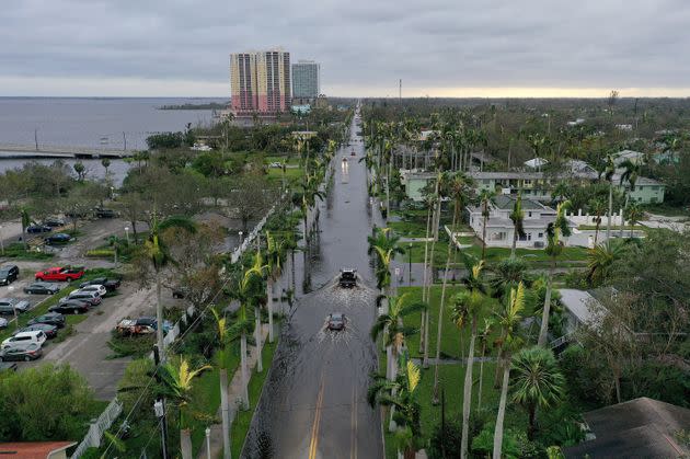 In this aerial view, vehicles make their way through a flooded area after Hurricane Ian passed through the area on Thursday in Fort Myers, Florida. (Photo: Joe Raedle via Getty Images)