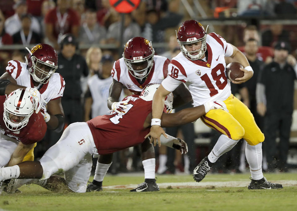 Southern California quarterback JT Daniels (18) breaks away from the tackle of Stanford defensive end Jovan Swann (51) during the second half of an NCAA college football game, Saturday, Sept. 8, 2018, in Stanford, Calif. (AP Photo/Tony Avelar)