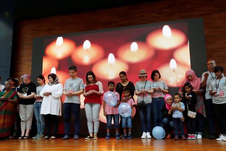 Family members hold candles during the fourth annual remembrance event for the missing Malaysia Airlines flight MH370, in Kuala Lumpur, Malaysia March 3, 2018. REUTERS/Lai Seng Sin/Files