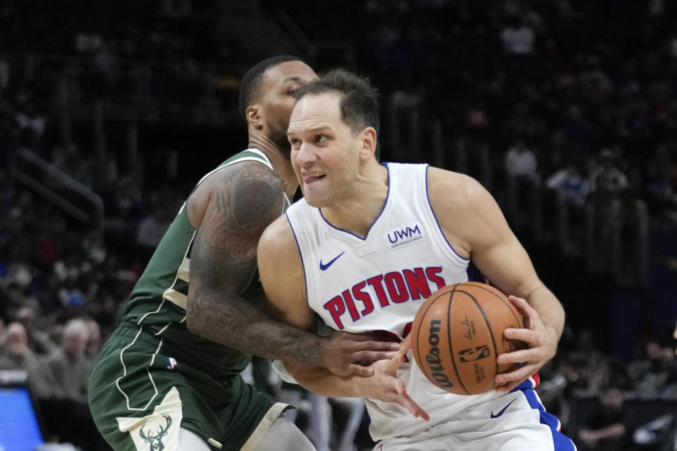 Detroit Pistons forward Bojan Bogdanovic (44) is fouled by Milwaukee Bucks guard Damian Lillard (0) in the second half of an NBA basketball game in Detroit, Monday, Jan. 22, 2024. (AP Photo/Paul Sancya)