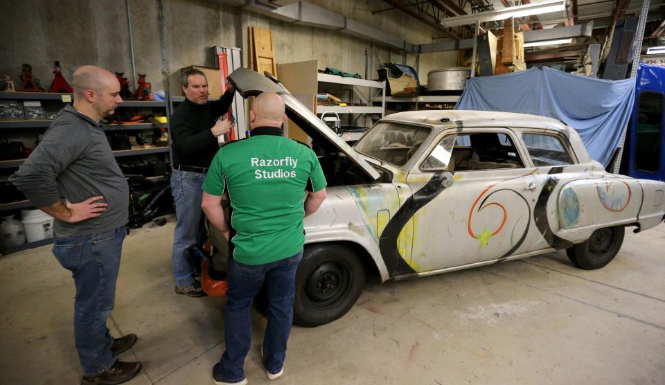 Staff from the North Carolina restoration company Razorfly Studios and the Studebaker National Museum check over the 1951 Studebaker Commander that was in the 1979 film "The Muppet Movie" on Friday, Jan. 12, 2024, in the museum's basement.