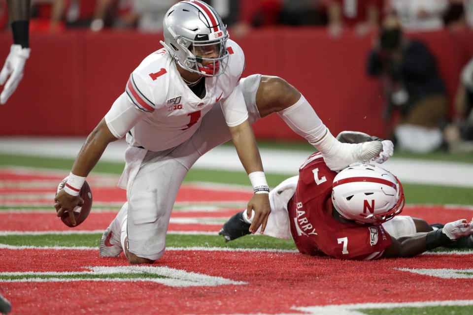 Ohio State quarterback Justin Fields (1) gets up after scoring a touchdown next to Nebraska linebacker Mohamed Barry (7) in Lincoln, Neb., Saturday, Sept. 28, 2019. (AP Photo/Nati Harnik)