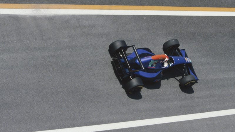 A photo of the blue Simtek F1 car racing at the Pacific Grand prix. 