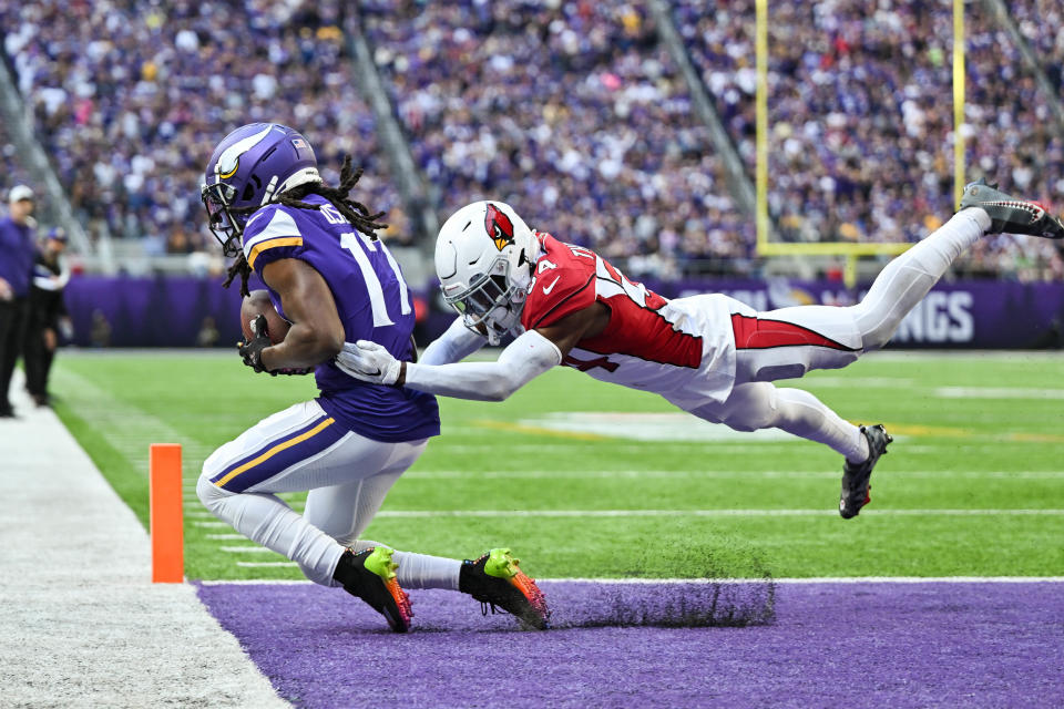 Vikings wide receiver K.J. Osborn (17) scores a touchdown as Cardinals safety Jalen Thompson (34) tries to break up the pass during the fourth quarter at U.S. Bank Stadium in Minneapolis.