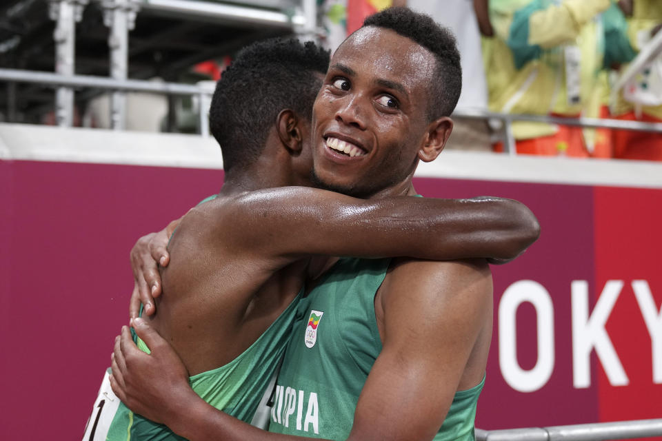 Selemon Barega, of Ethiopia, left, celebrates with compatriot Berihu Aregawi after winning the men's 10,000-meters final at the 2020 Summer Olympics, Friday, July 30, 2021, in Tokyo. (AP Photo/Matthias Schrader,Pool)