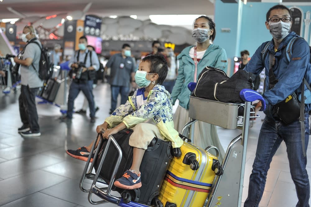 People are seen wearing protective masks at the arrival hall in KLIA 2, Sepang January 27, 2020. — Picture by Shafwan Zaidon