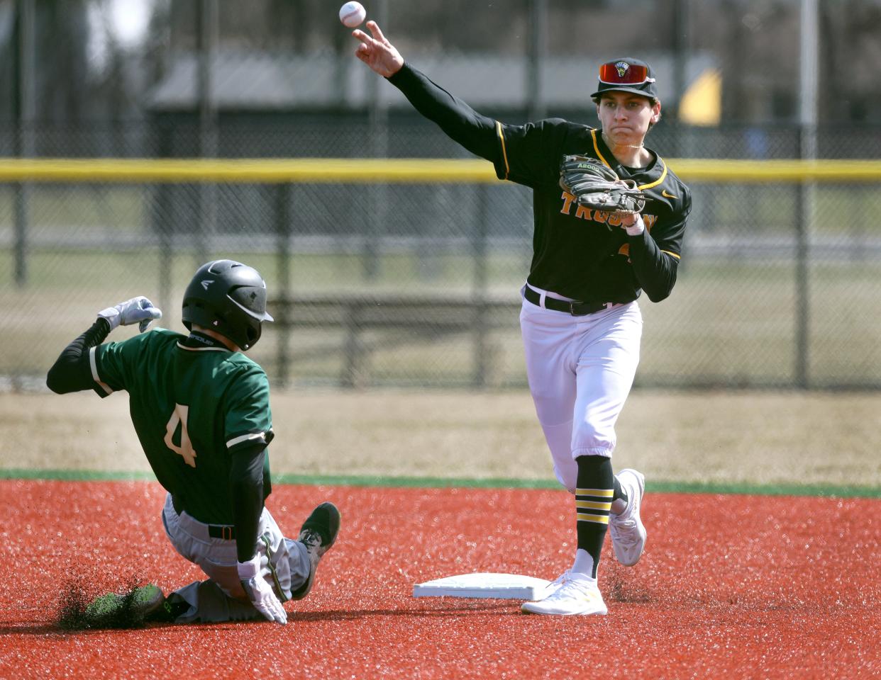 Athena’s Sammy Saucke turns double play ahead of the sliding Charles Sobaszek.