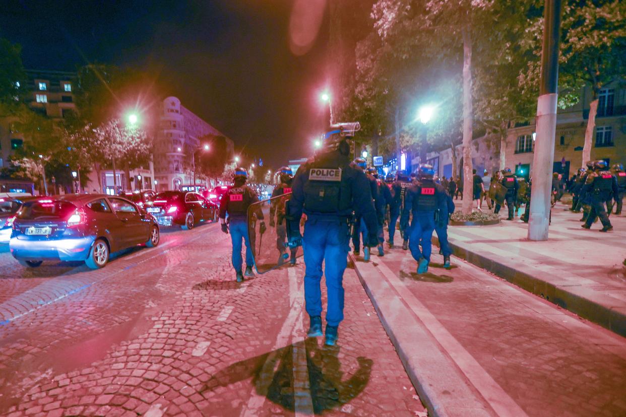 Riot police forces secure the area in front of the Arc de triomphe amid fears of another night of clashes with protestors in Paris, France (EPA)