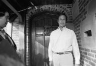 H.R. Haldeman, once a top Presidential advisor, is alternately somber and laughing as he poses briefly at the door of his Los Angeles home, March 1, 1974, shortly after a federal grand jury Washington indicted him and six others on charge of conspiring and lying to block the Watergate investigations. (AP Photo/George Birch)