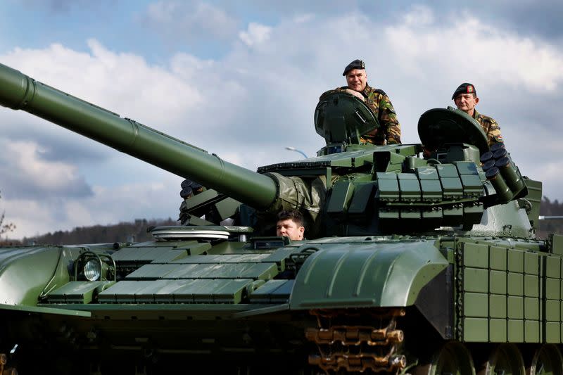 Commander of the Armed Forces of Netherlands Onno Eichelsheim stands in a T-72AE tank that passes the arms factory in Sternberk