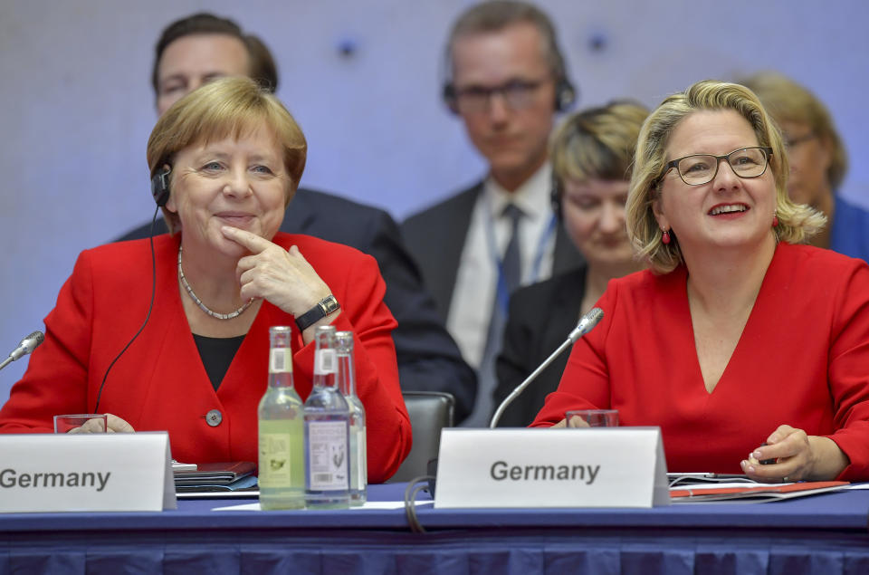 German Chancellor Angela Merkel, left, and German Environment Minister Svenja Schulze attend the 10th Petersberger Klimadialog climate conference in Berlin, Germany, Tuesday, May 14, 2019. (Tobias Schwarz/Pool via AP)
