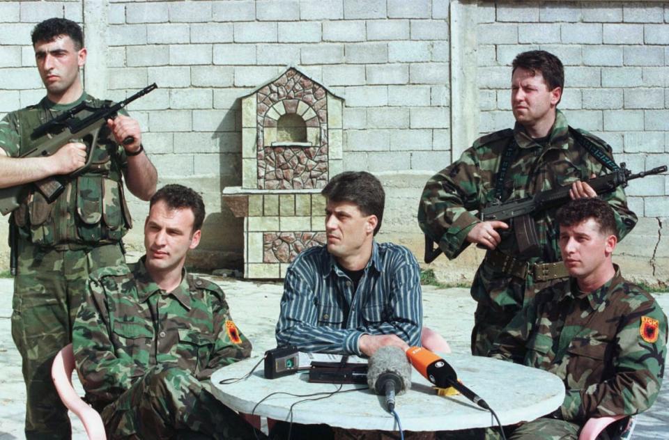 <div class="inline-image__caption"><p>Hashim Thaçi, center, the Kosovo Liberation Army (KLA) political chief talks at a news conference in the town of Trpeza on March 13, 1999.</p></div> <div class="inline-image__credit">Oleg Popov/Reuters</div>