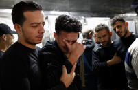 Relatives mourn during the funeral of Reema Telbani and her 5-year-old son Zaid, who were killed in Israeli airstrikes on their family apartment building, at Dar Al-Shifa Hospital in Gaza City, Wednesday, May 12, 2021. (AP Photo/Adel Hana)