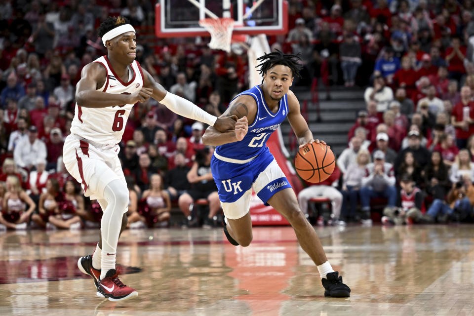 Kentucky guard D.J. Wagner (21) drives past Arkansas guard Layden Blocker (6) during the first half of an NCAA college basketball game Saturday, Jan. 27, 2024, in Fayetteville, Ark. (AP Photo/Michael Woods)