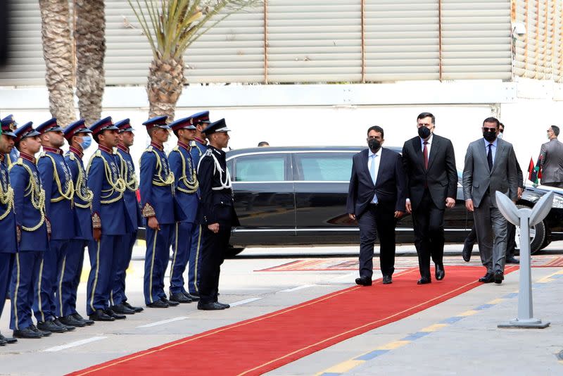 Libya's Prime Minister Abdulhamid Dbeibeh, Libya's internationally recognized former Prime Minister Fayez al-Sarraj, and Mohammed al-Menfi, Head of the Presidency Council, arrive ahead of the handover ceremony in Tripoli