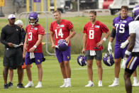 Minnesota Vikings quarterbacks Jake Browning, Nate Stanley and Kirk Cousins, from left, wait their turns at passing drills during the NFL football team's training camp Thursday, Aug. 5, 2021, in Eagan, Minn. (AP Photo/Jim Mone)