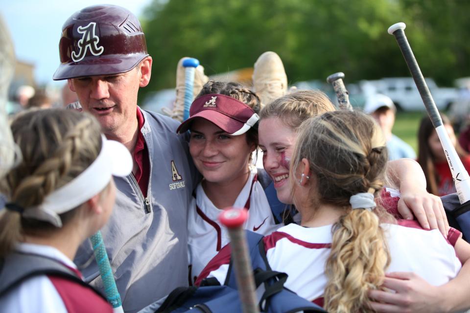 Arlington softball's head coach Dave Ballantyne embraces his players after losing to White Plains in the Section 1 Class AA softball semifinal on May 24, 2022. 