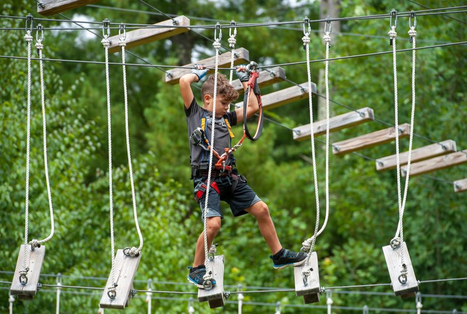 Kolton Scanlon, 7, of Uxbridge, at Boundless Adventures zipline and aerial adventure park in West Berlin, Aug. 10, 2022.