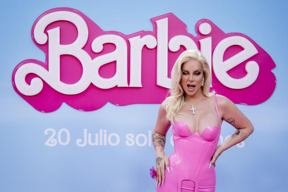 Jedet, wearing a pink latex dress, winks and poses on the pink carpet for the special screening of the movie 'Barbie' at the Gran Teatro CaixaBank
