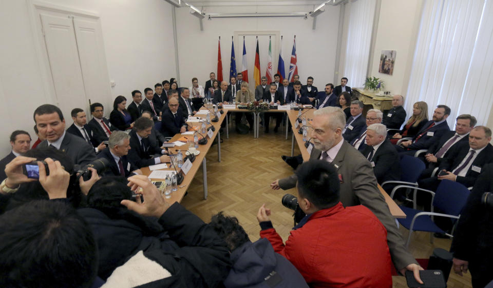 The European Union's political director Helga Schmid and Iran's deputy Foreign Minister Abbas Araghchi, center from left, wait for a bilateral meeting as part of the closed-door nuclear talks with Iran in Vienna, Austria, Friday, Dec. 6, 2019. (AP Photo/Ronald Zak)