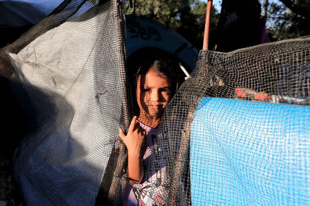 A migrant girl looks on at a makeshift camp next to the Moria camp for refugees and migrants on the island of Lesbos, Greece, September 17, 2018. Picture taken September 17, 2018. REUTERS/Giorgos Moutafis