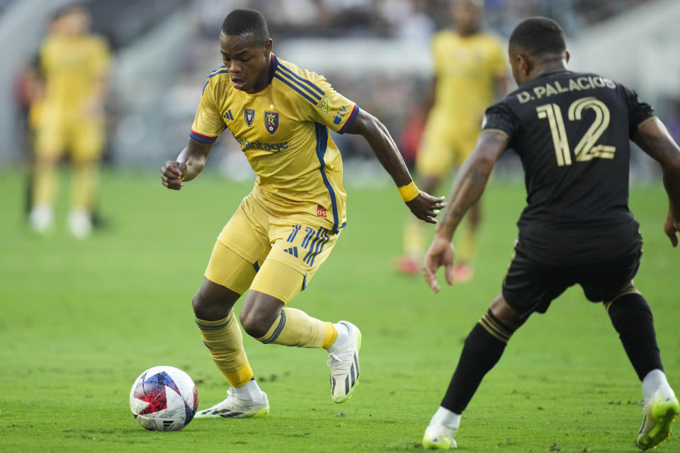 Real Salt Lake forward Carlos Andrés Gómez, left, dribbles under defense by Los Angeles FC defender Diego Palacios, right, during the first half of an MLS soccer match Sunday, Oct. 1, 2023, in Los Angeles. (AP Photo/Jae C. Hong)