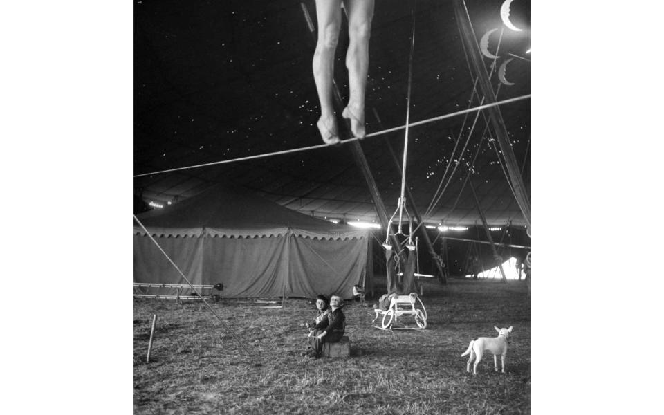 <p>Aerialist Miss Lola practiced on a tightrope as the performer?s children looked on in 1949.</p>