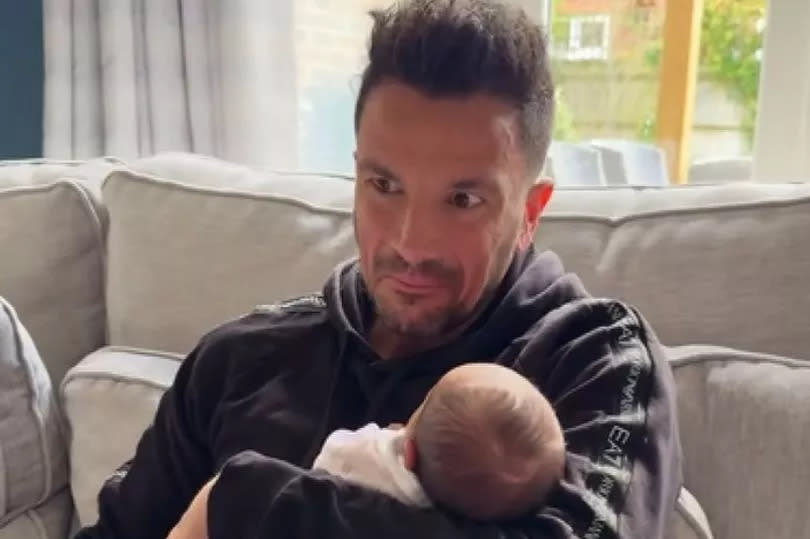 Peter Andre hold his baby daughter who does not yet have a name