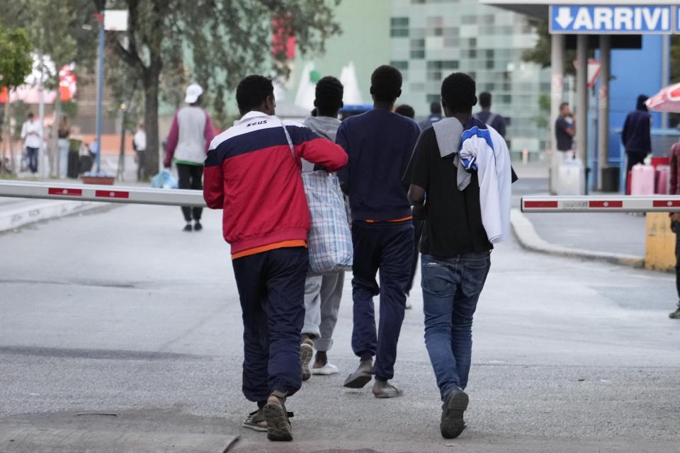 Migrants walk towards a station to board a bus directed to Marseille, France, in Rome, Tuesday, Sept. 12, 2023. Despite vows by Italy’s right-wing government to crack down on migrant arrivals and European Union-inked deals with Tunisia to stem the flow, the numbers of desperate people making the dangerous Mediterranean crossing keep rising. (AP Photo/Gregorio Borgia)