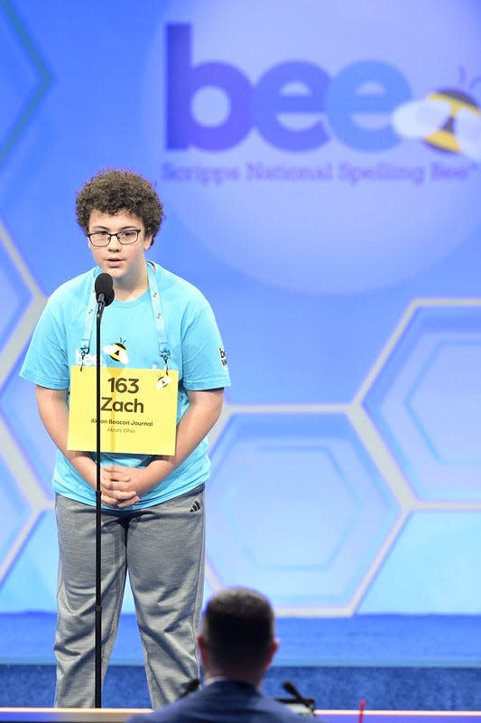 Zachary Yeager of Doylestown, representing The Akron Beacon Journal in the Scripps National Spelling Bee, works with the pronouncer during Tuesday's early rounds of competition. Yeager was successful in his first three rounds of the bee, and will compete Wednesday in Oxon Hill, Maryland.