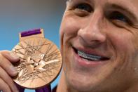 US swimmer Ryan Lochte poses with his bronze medal after the podium ceremony for the men's 200m backstroke swimming event at the London 2012 Olympic Games in London. Lochte's London Olympics ended with a whimper on Thursday as a brutal backstroke-medley double failed to yield gold and he succumbed yet again to old foe Michael Phelps