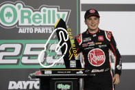 Christopher Bell celebrates in Victory Lane after winning the NASCAR Cup Series road course auto race at Daytona International Speedway, Sunday, Feb. 21, 2021, in Daytona Beach, Fla. (AP Photo/John Raoux)